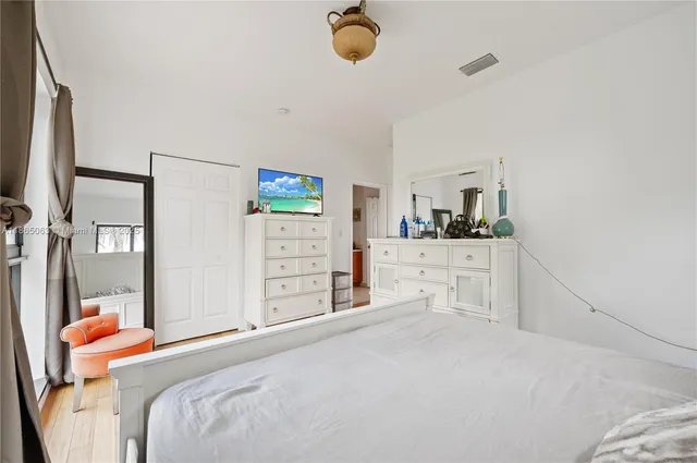 a bedroom with a bed and cabinets