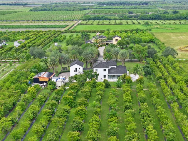 a front view of a house with a garden and yard
