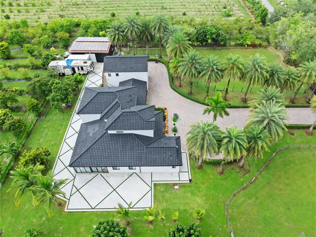 an aerial view of a house with garden space and lake view