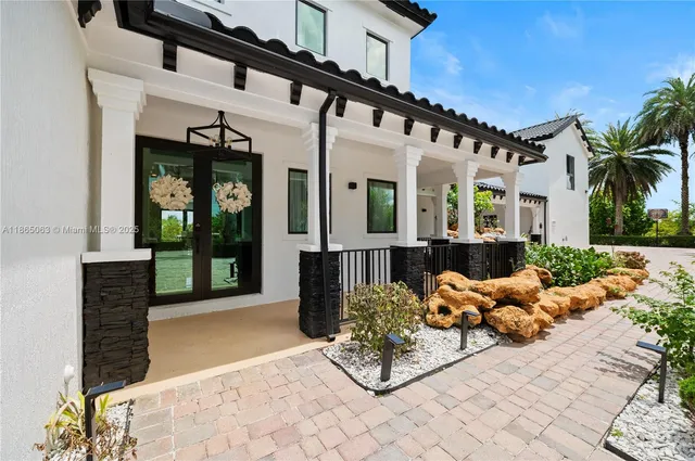 a building outdoor space with patio furniture and potted plants