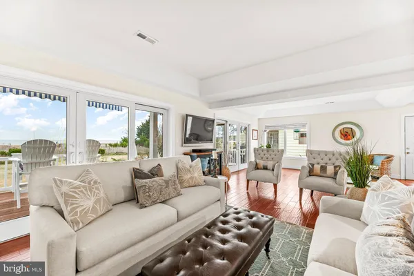 a utility room with stainless steel appliances granite countertop a sink a washer and dryer with wooden cabinets