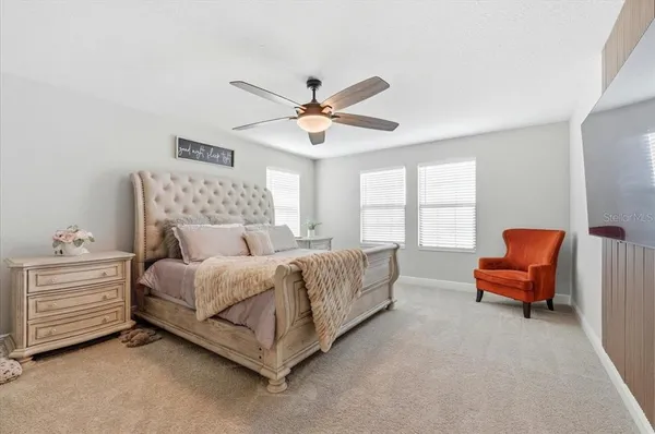a bedroom with a bed and a couch