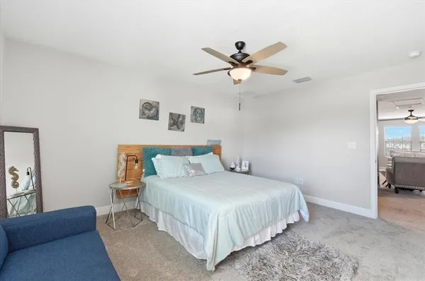 a bedroom with a bed and a view of en suite bathroom