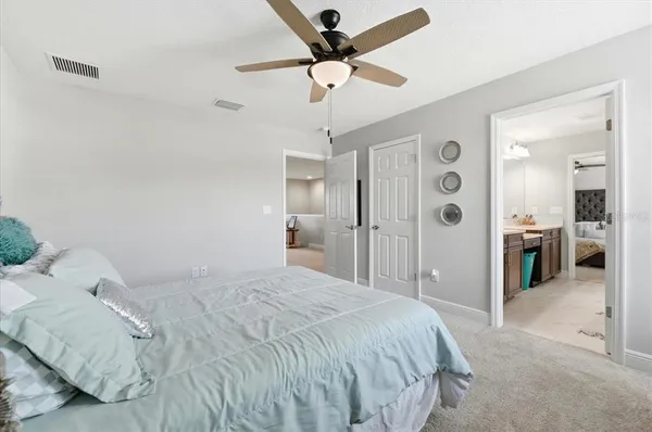 a bedroom with a bed and a chandelier