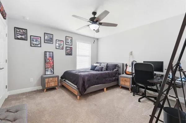 a bedroom with a bed and a desk