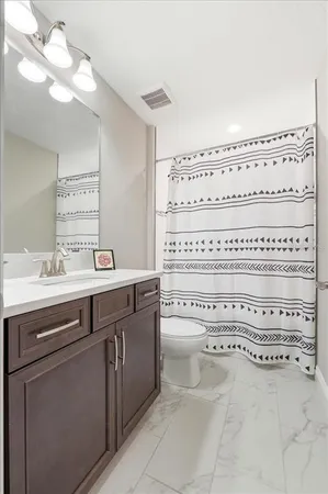 a bathroom with a sink a vanity and a mirror