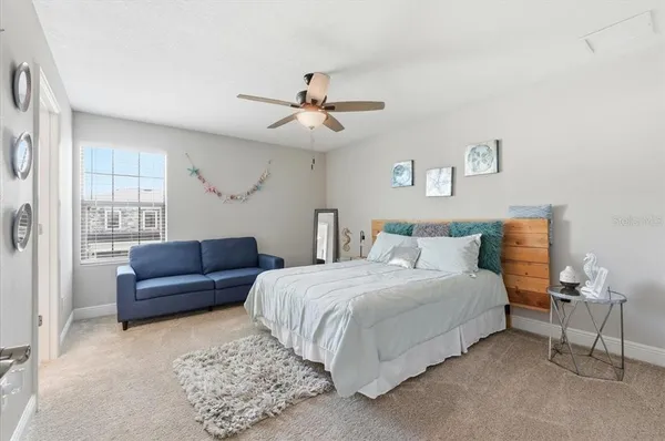 a bedroom with a bed couch and window