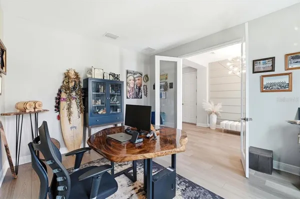 a view of a workspace with furniture and a window
