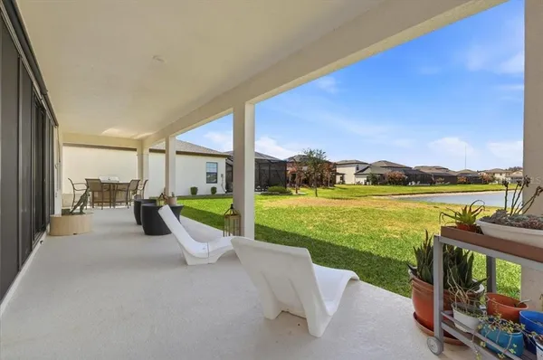 a view of swimming pool with outdoor seating and yard