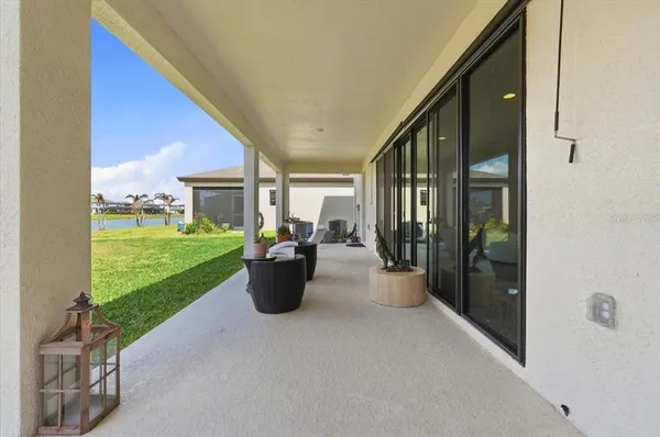 a view of a porch with furniture and garden
