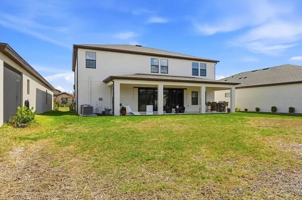 a view of a house with a backyard