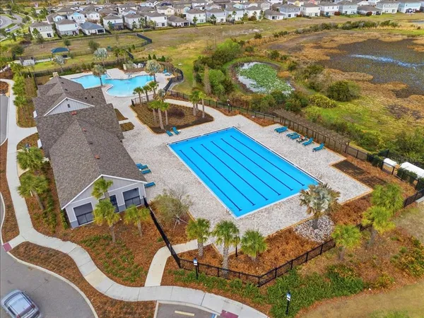 an aerial view of a house with a swimming pool patio and lake view