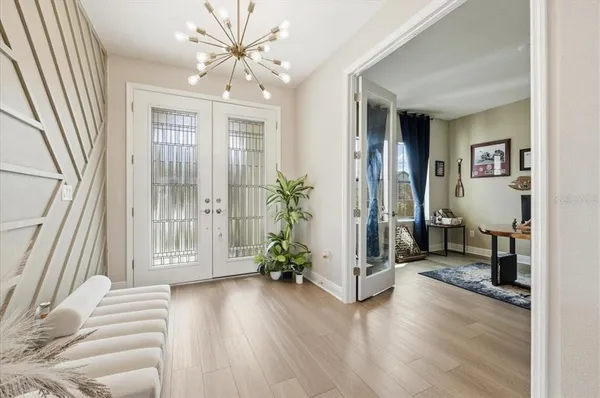 a view of a livingroom with wooden floor and a balcony