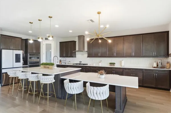 a large kitchen with a table and chairs