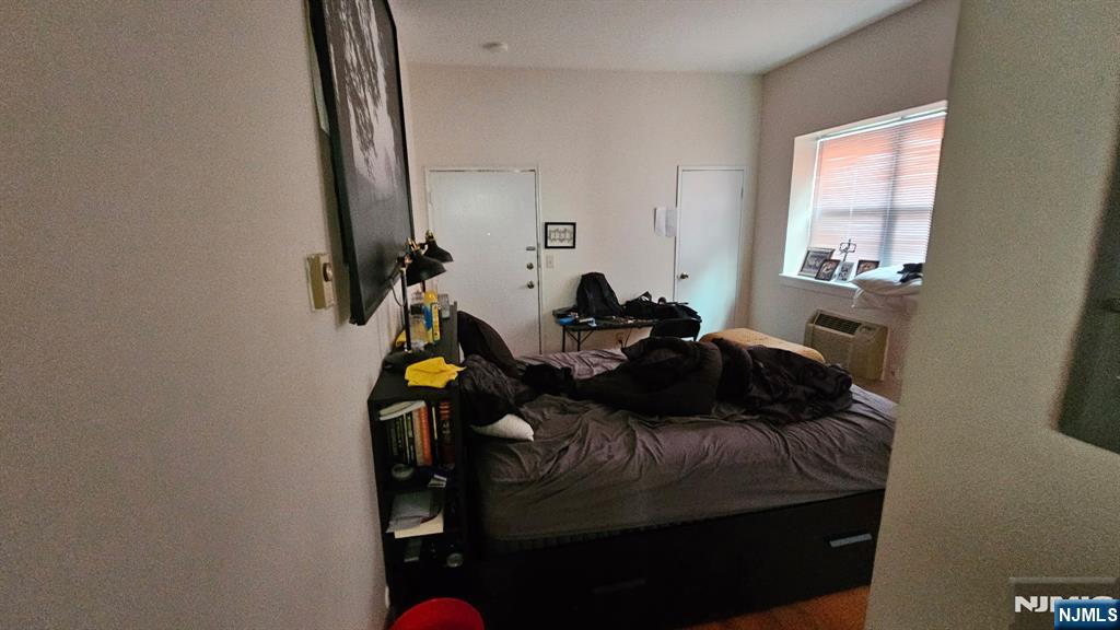 467 Hudson Street Hackensack, NJ 07601 - Photo 11 of 13 a bedroom with a bed and a window
