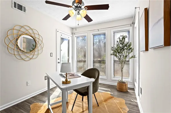 a view of a livingroom with furniture and a window
