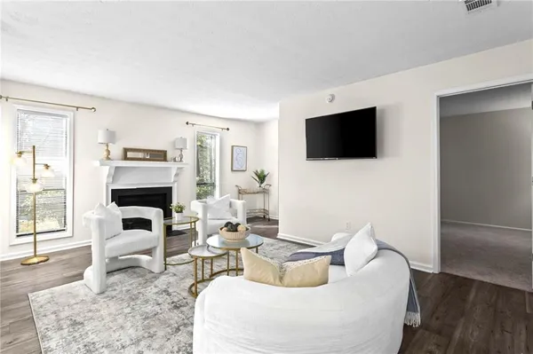 a living room with fireplace furniture and a flat screen tv