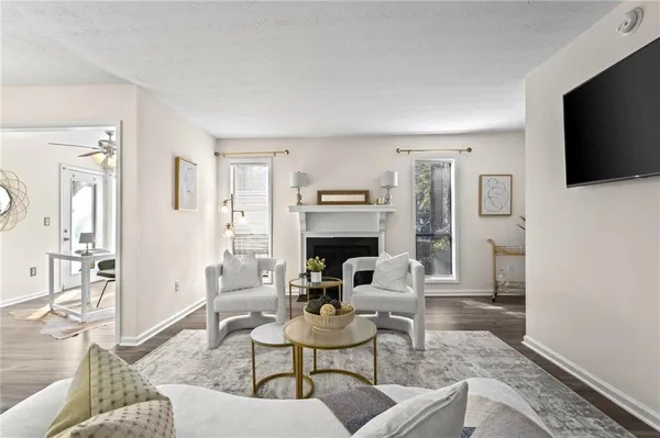 a living room with fireplace furniture and a flat screen tv