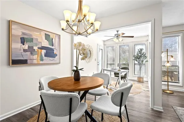 a dining room with furniture wooden floor and a chandelier