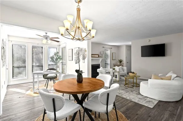 a view of a dining room with furniture wooden floor and chandelier
