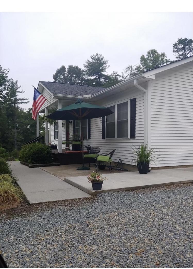 8757 Henry Road Henry, VA 24102 - Photo 1 of 21 a view of a house with backyard and sitting area