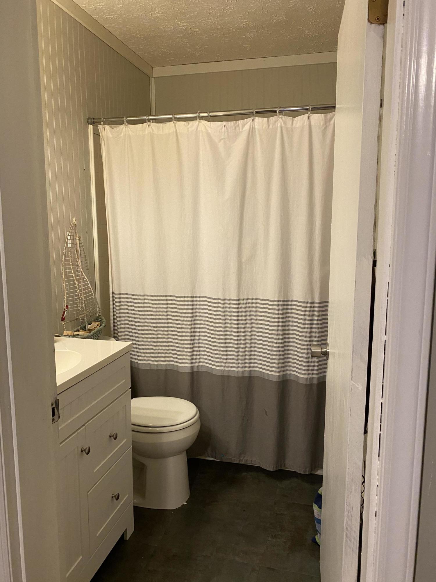 8757 Henry Road Henry, VA 24102 - Photo 16 of 21 a bathroom with a sink a toilet and shower