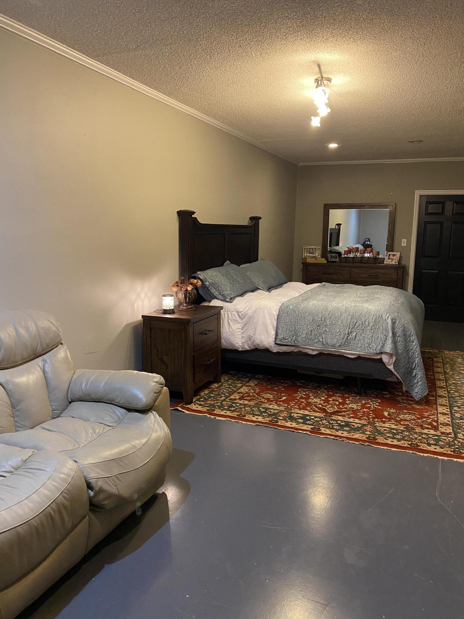 8757 Henry Road Henry, VA 24102 - Photo 18 of 21 a bedroom with a bed and wooden floor
