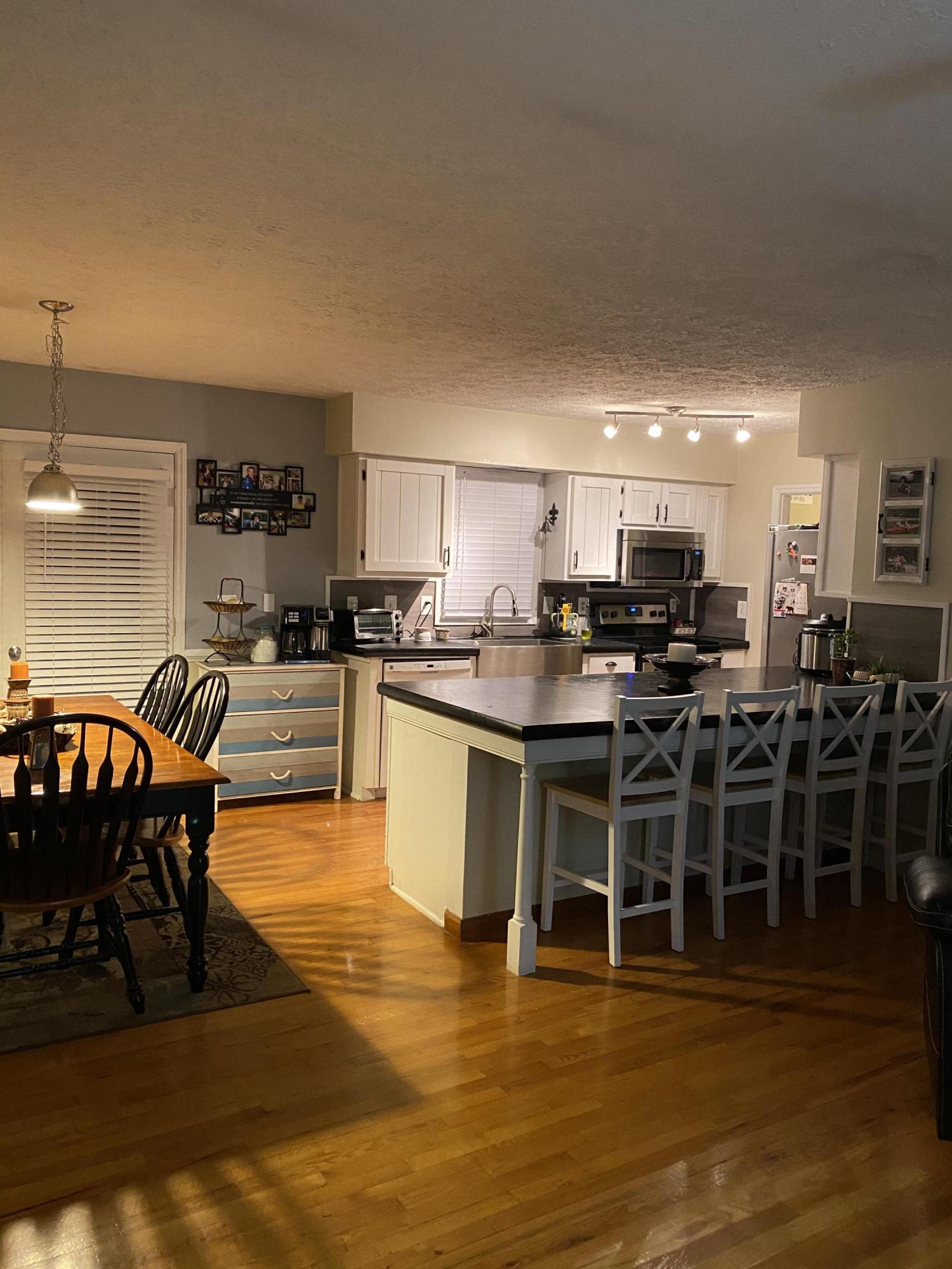 8757 Henry Road Henry, VA 24102 - Photo 6 of 21 a kitchen with stainless steel appliances kitchen island granite countertop a stove a sink a dining table and chairs
