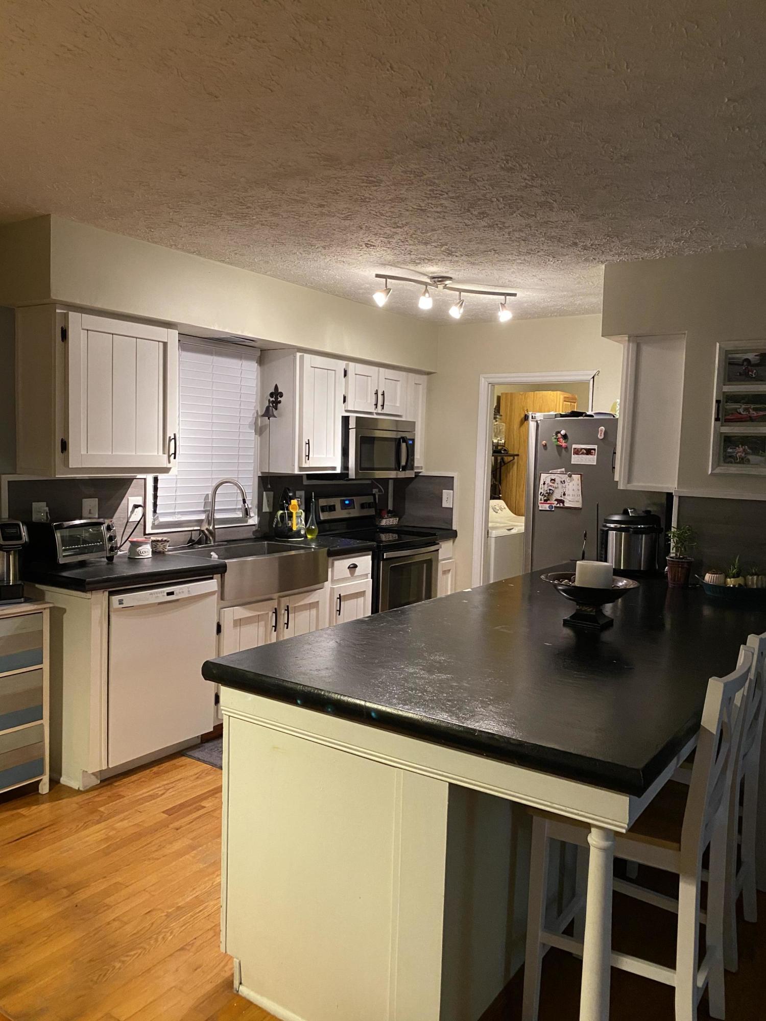 8757 Henry Road Henry, VA 24102 - Photo 7 of 21 a kitchen with stainless steel appliances granite countertop a sink a stove counter space and cabinets