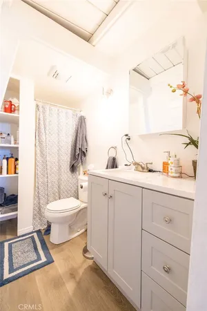 a bedroom with a bed and a mirror