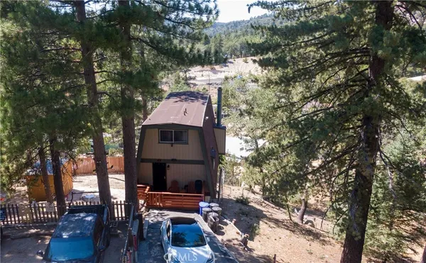 a view of a porch with chairs and a floor to ceiling window