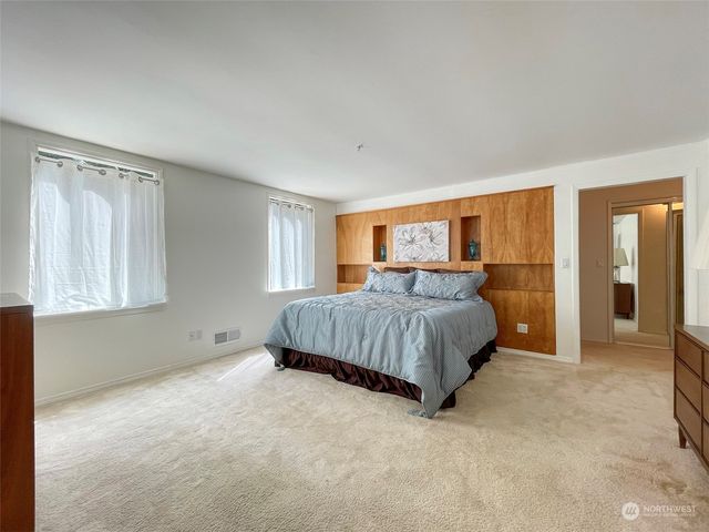a view of livingroom with kitchen view and a hallway