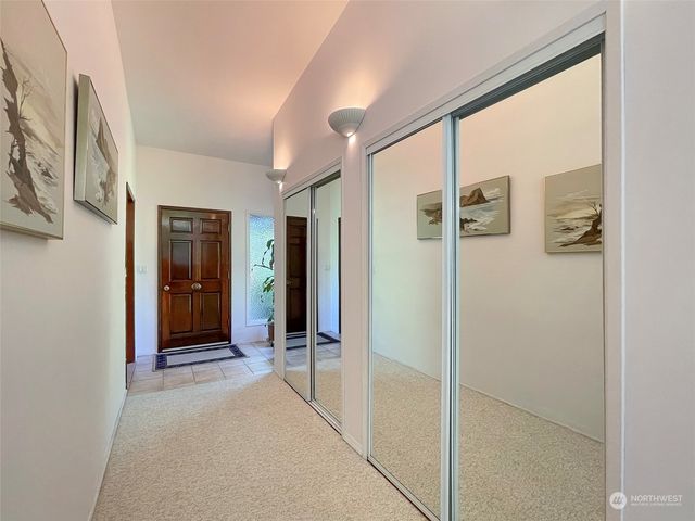 a view of a hallway with wooden shelves