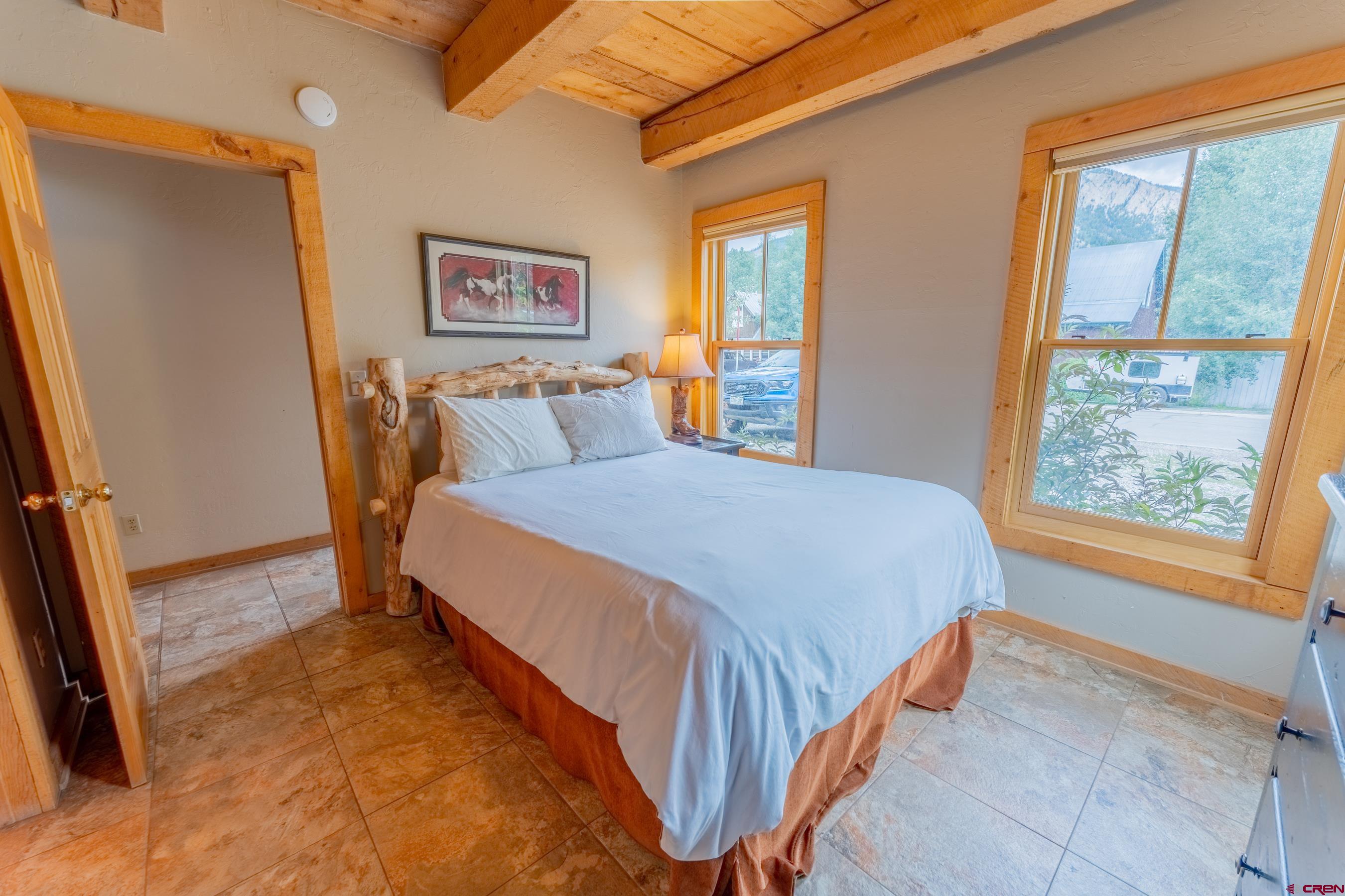 13 7th Street Crested Butte, CO 81224 - Photo 13 of 35 a bed sitting in a bedroom next to a window