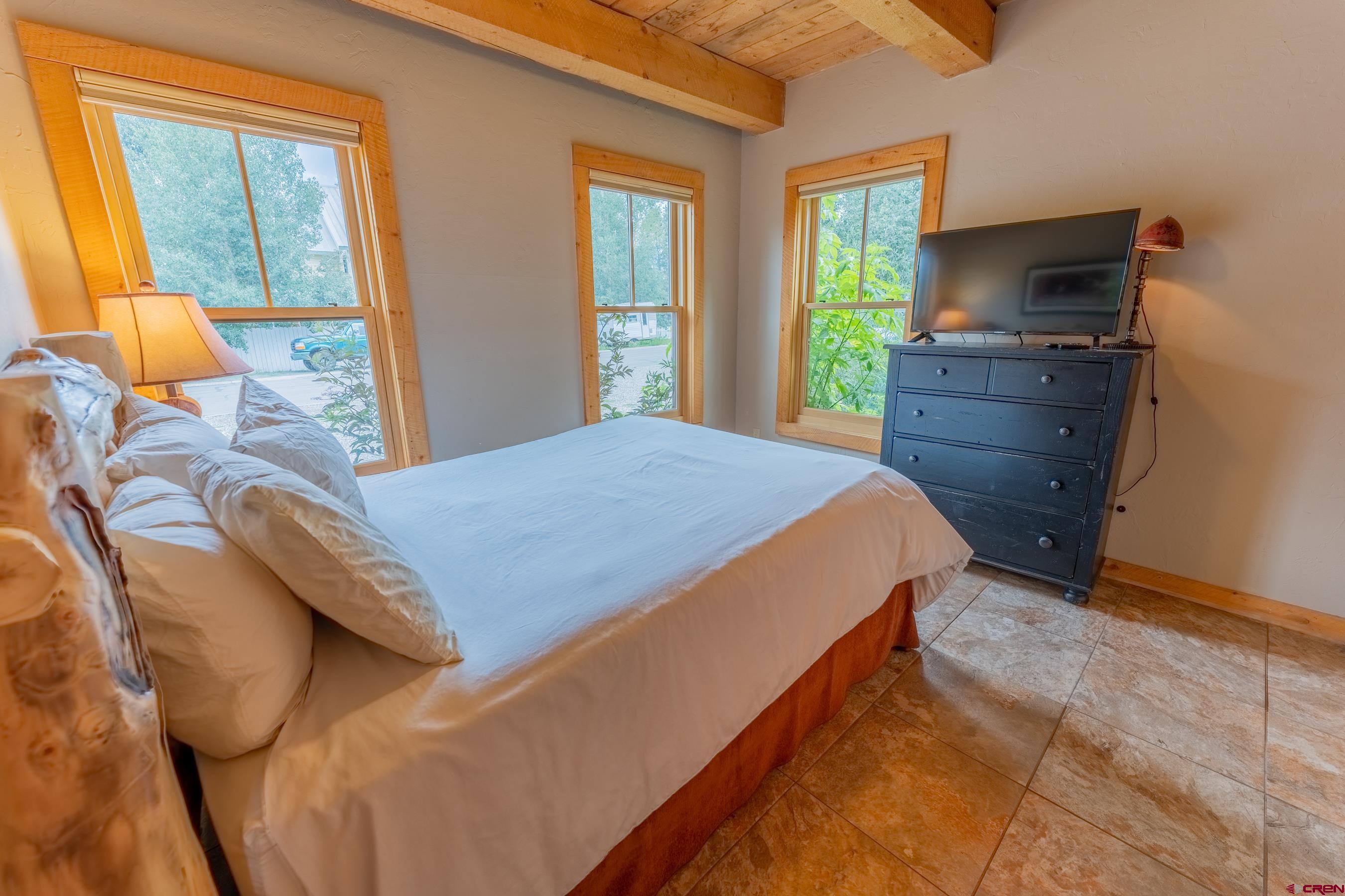 13 7th Street Crested Butte, CO 81224 - Photo 14 of 35 a bedroom with a bed and wooden floor