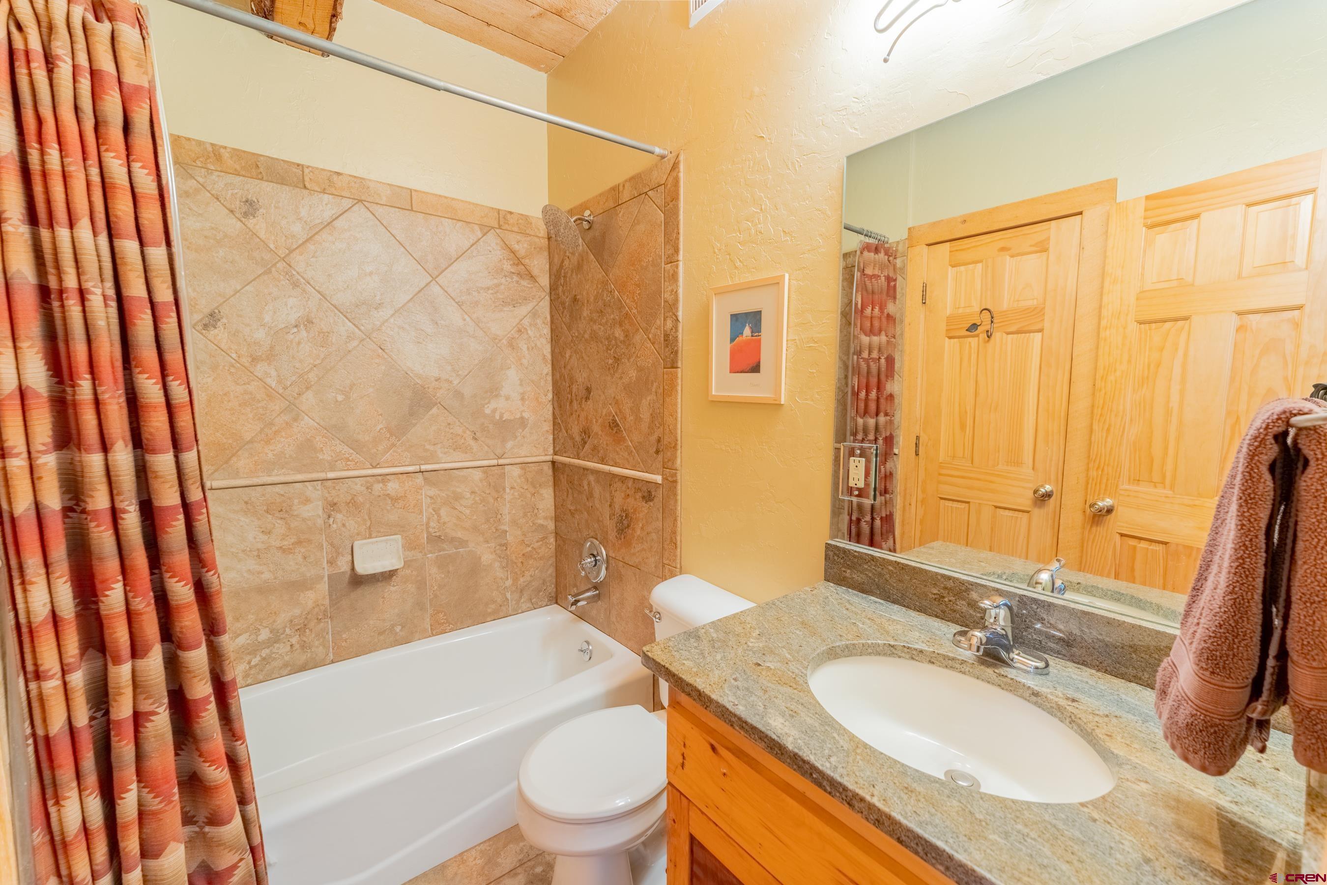 13 7th Street Crested Butte, CO 81224 - Photo 15 of 35 a bathroom with a granite countertop sink toilet and shower