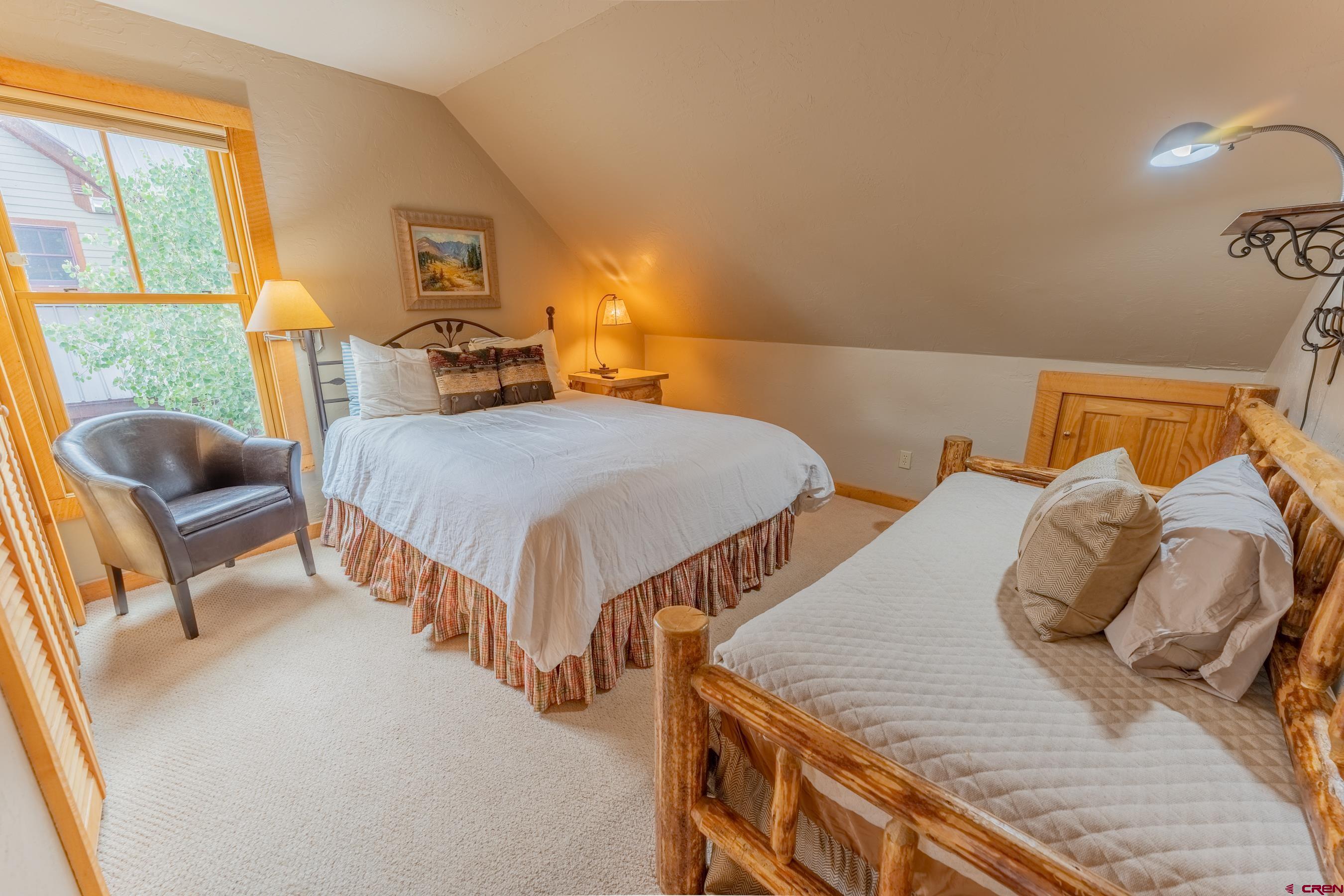13 7th Street Crested Butte, CO 81224 - Photo 16 of 35 a bedroom with two beds and next to a window