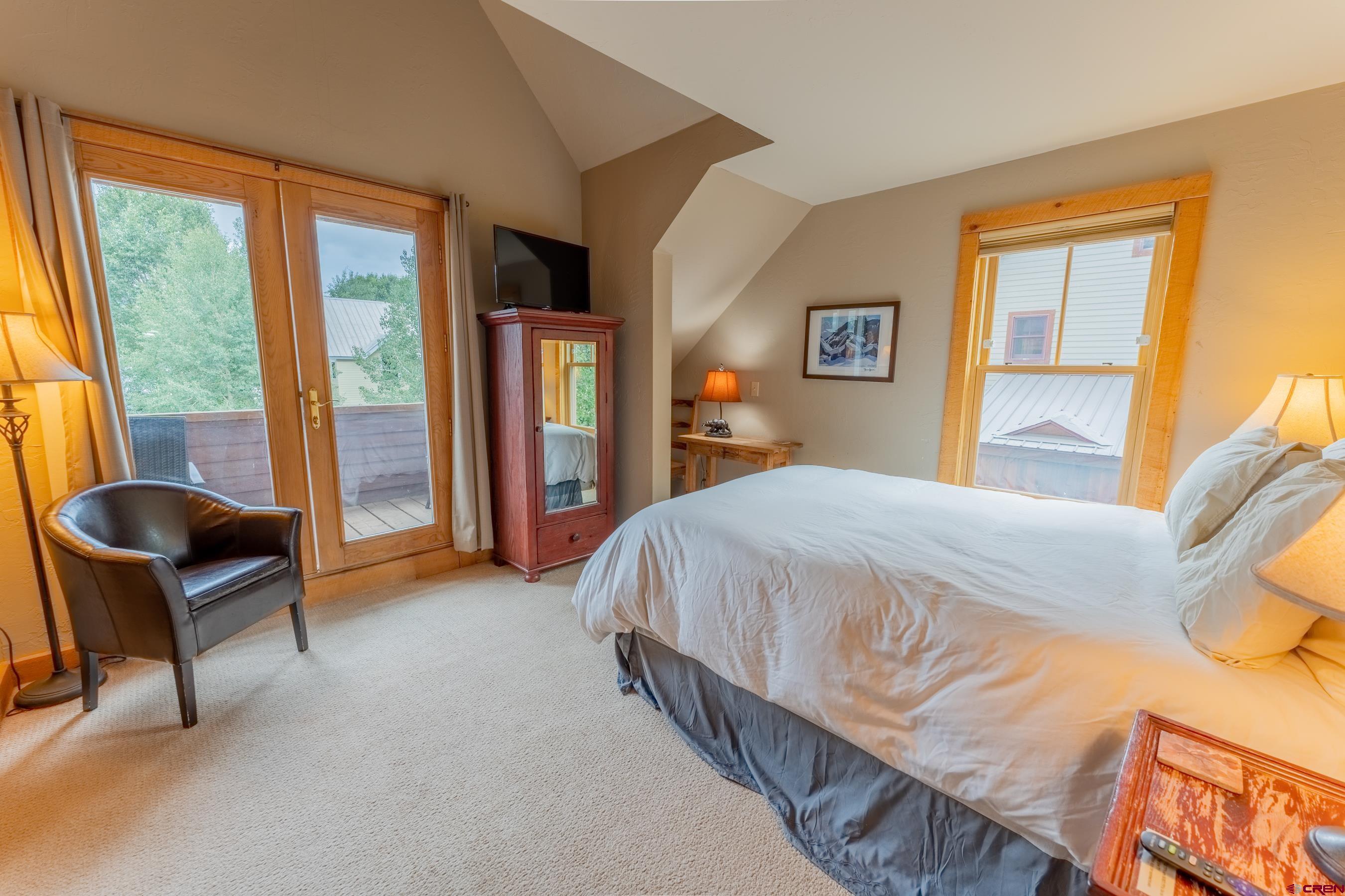 13 7th Street Crested Butte, CO 81224 - Photo 20 of 35 a spacious bedroom with a bed and chair