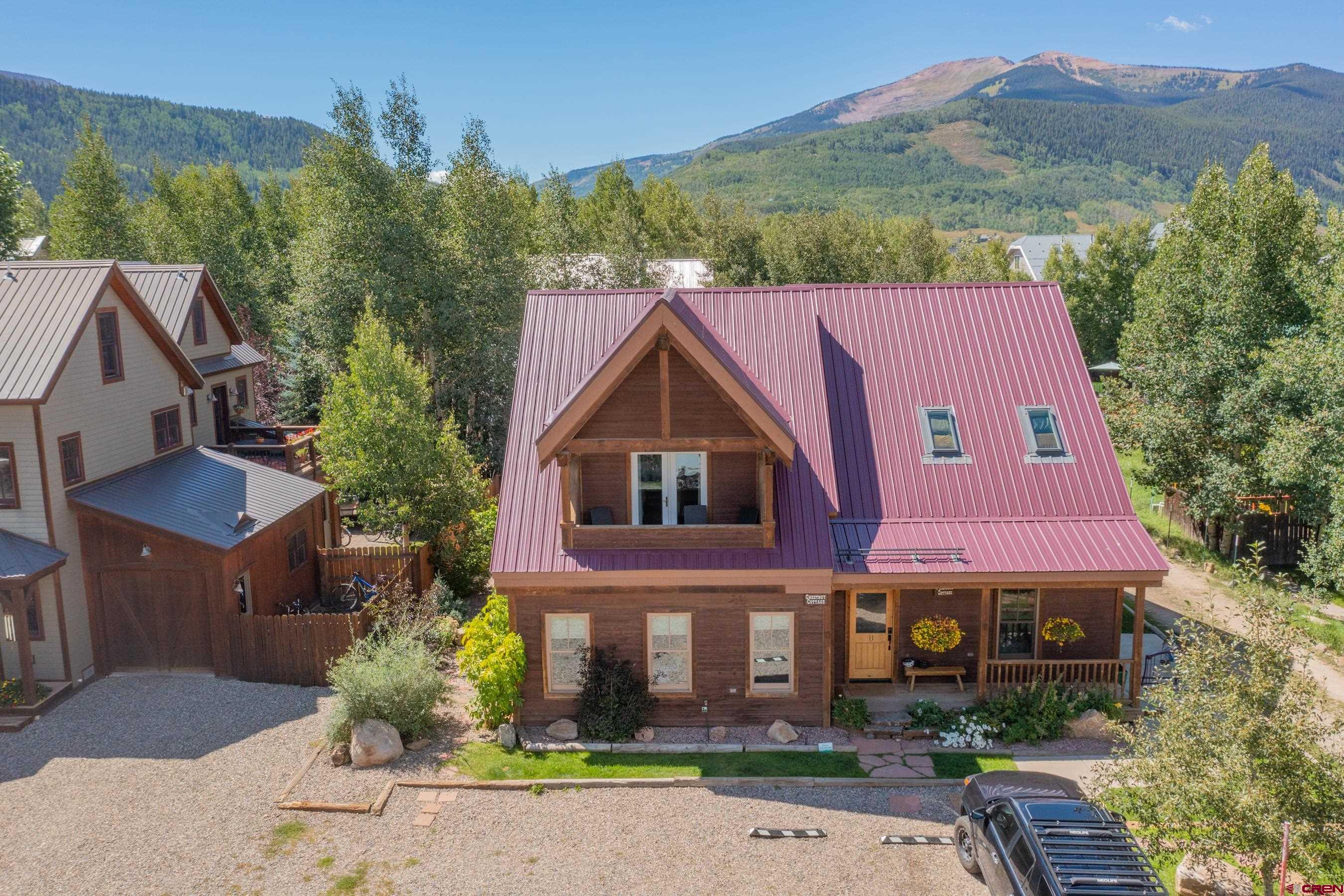13 7th Street Crested Butte, CO 81224 - Photo 2 of 35 a view of a house with a yard and large tree