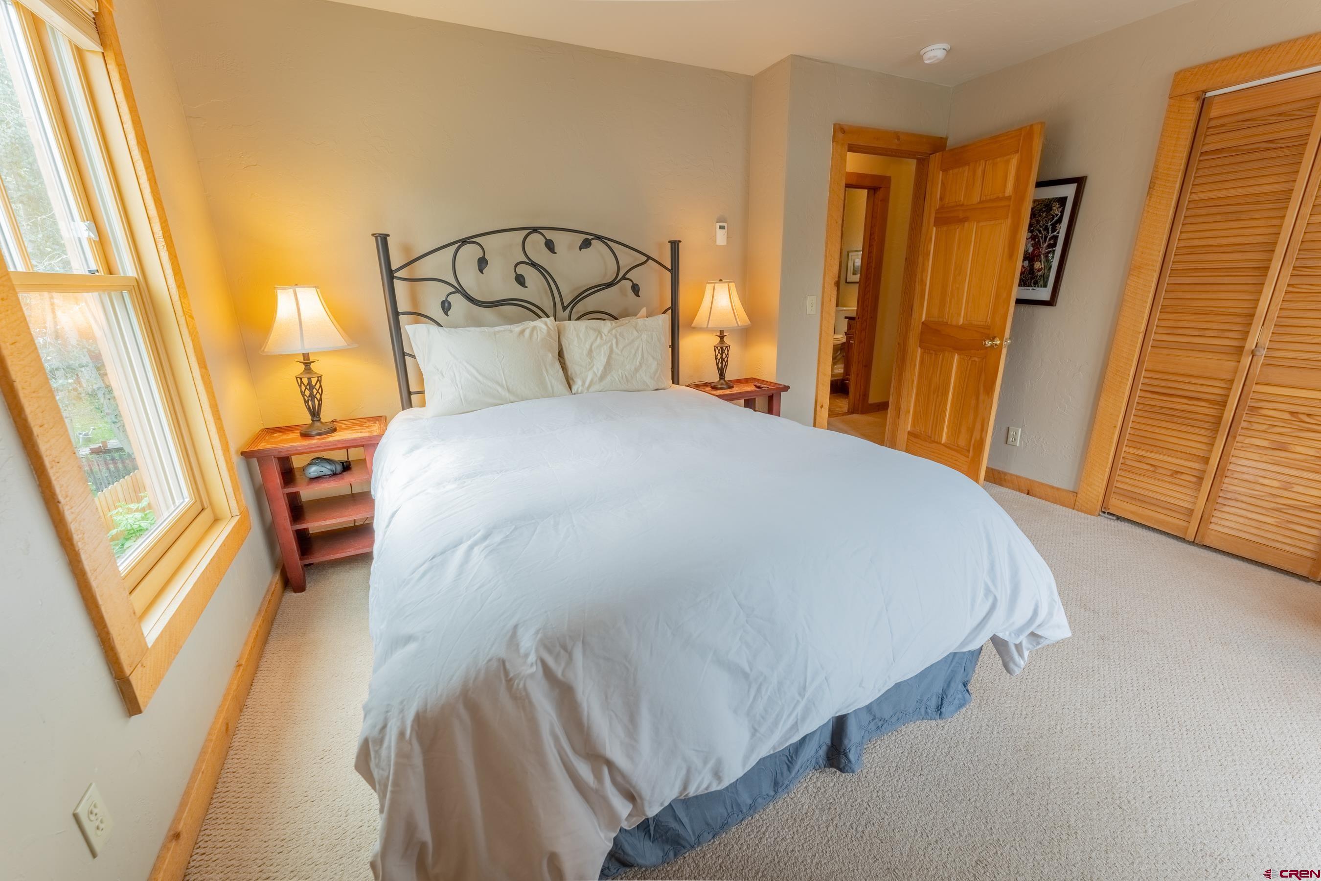 13 7th Street Crested Butte, CO 81224 - Photo 22 of 35 a bedroom with a bed and a mirror