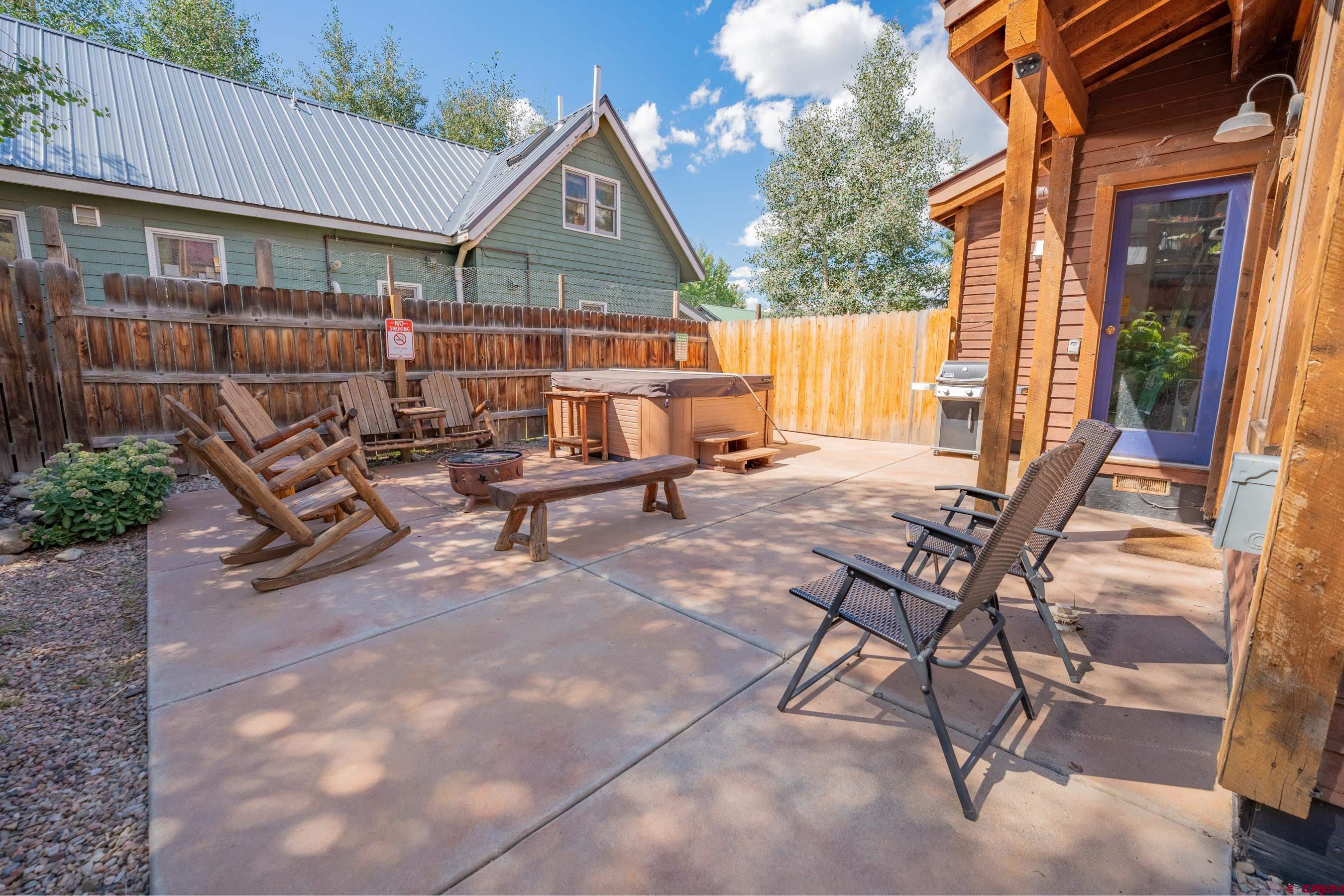 13 7th Street Crested Butte, CO 81224 - Photo 28 of 35 a view of a patio with table and chairs with wooden fence and plants