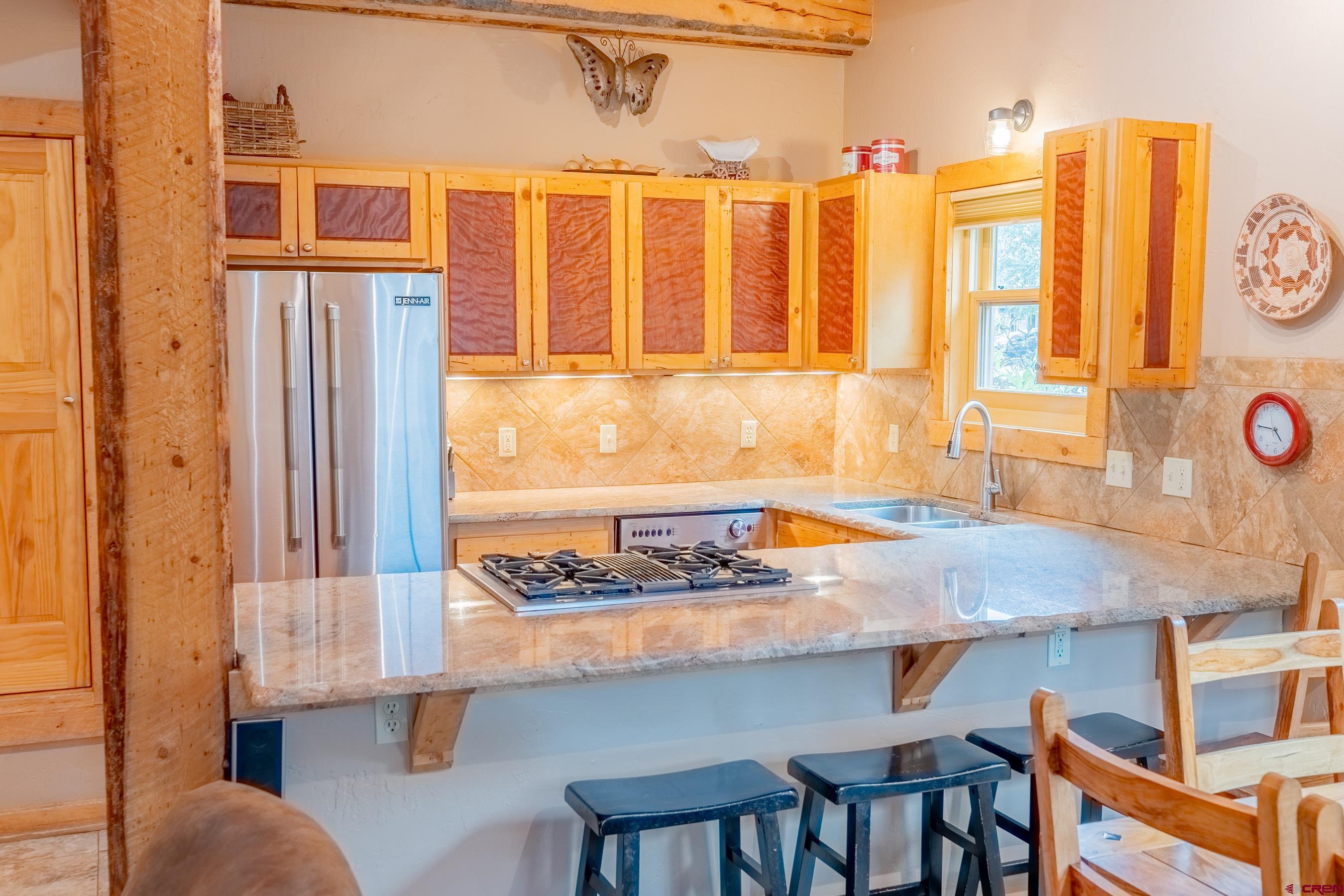 13 7th Street Crested Butte, CO 81224 - Photo 5 of 35 a view of a kitchen area with furniture and large windows
