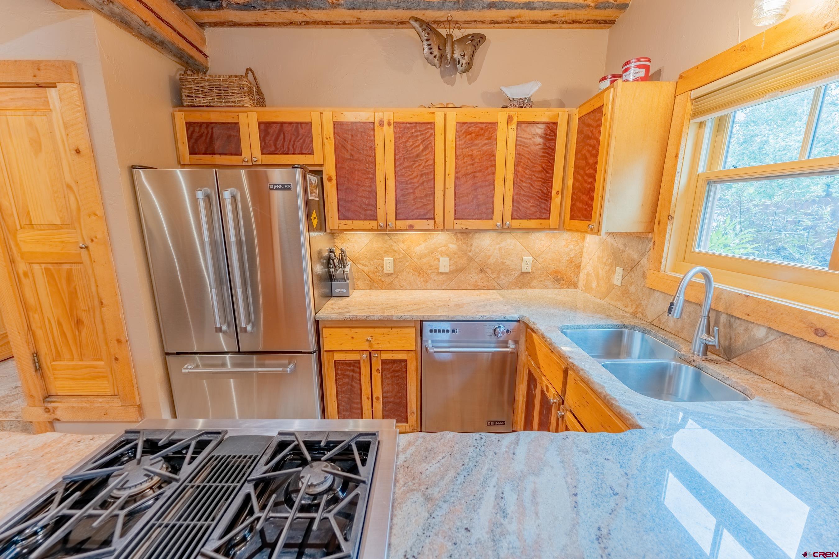 13 7th Street Crested Butte, CO 81224 - Photo 7 of 35 a kitchen with stainless steel appliances granite countertop a refrigerator and a sink
