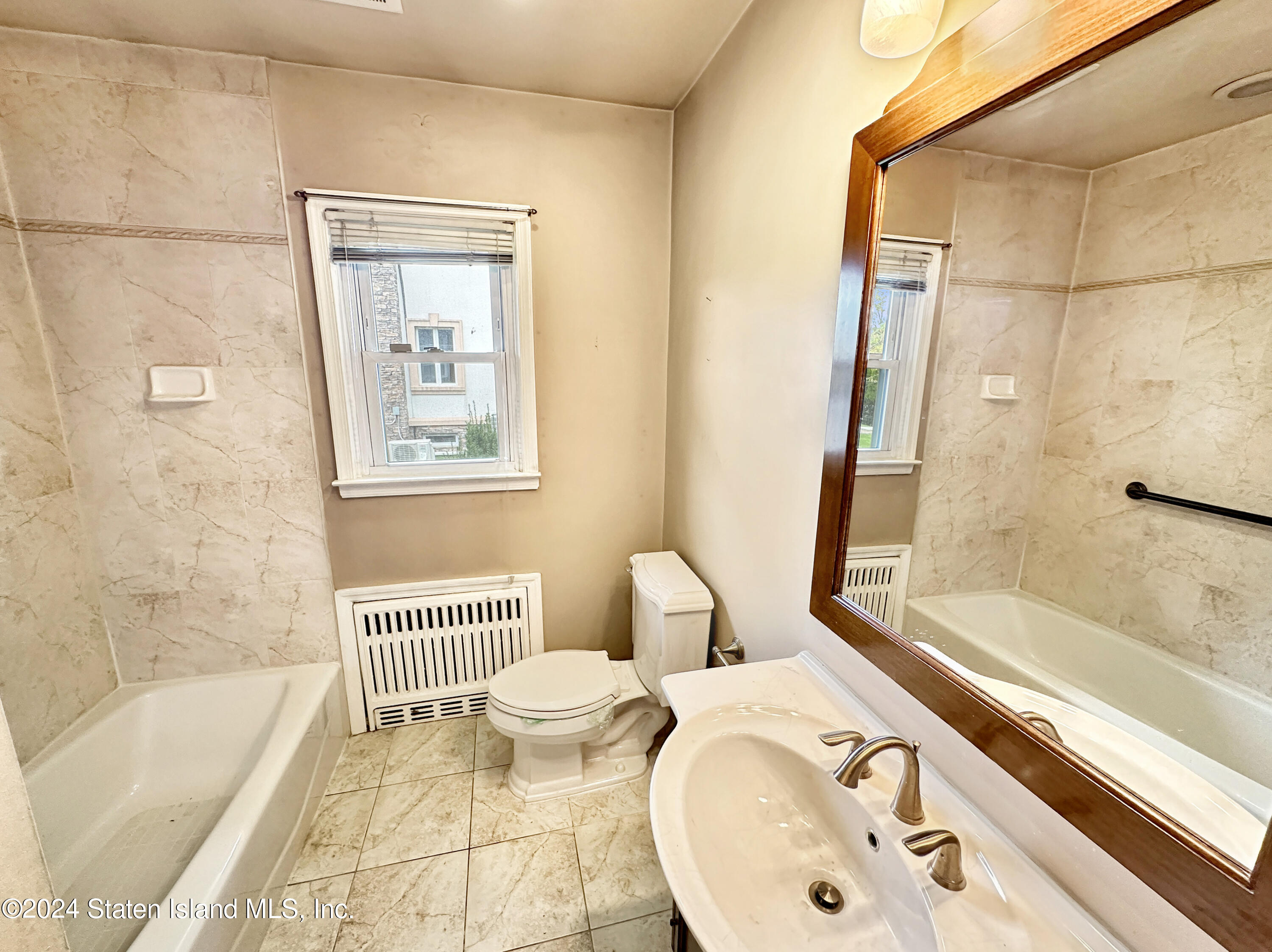 1085 Todt Hill Road Staten Island, NY 10304 - Photo 13 of 14 a bathroom with a sink toilet and shower