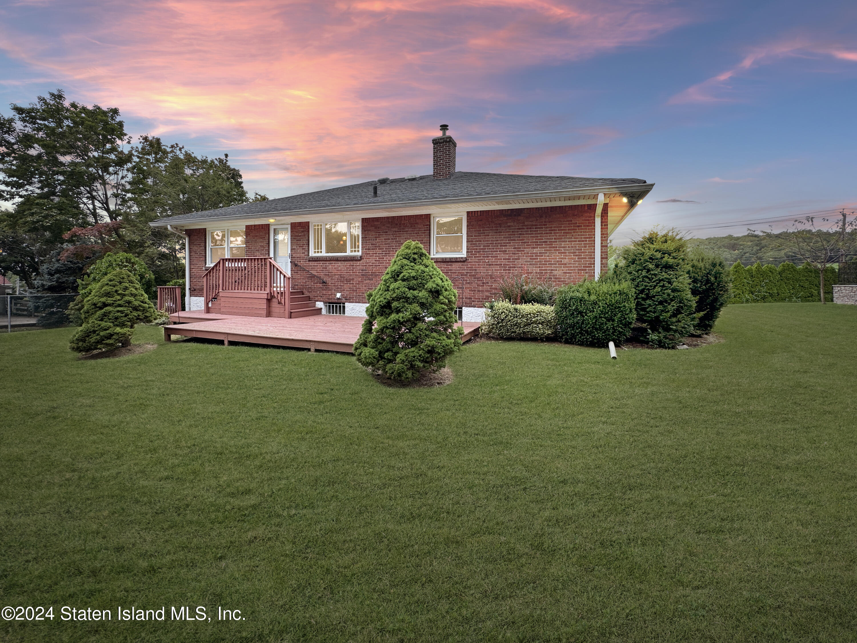1085 Todt Hill Road Staten Island, NY 10304 - Photo 2 of 14 a front view of a house with a garden
