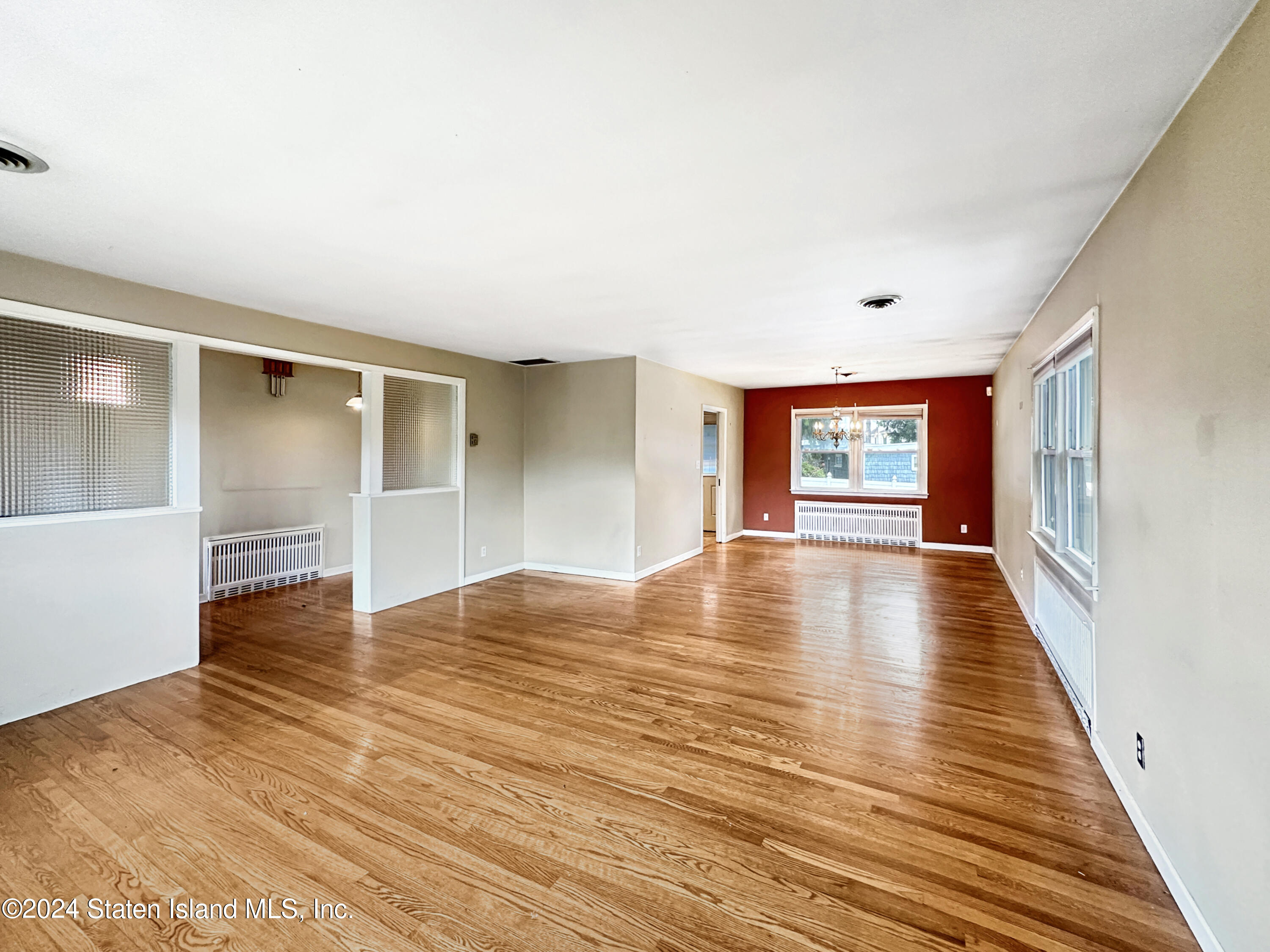 1085 Todt Hill Road Staten Island, NY 10304 - Photo 7 of 14 a view of empty room with wooden floor and fan