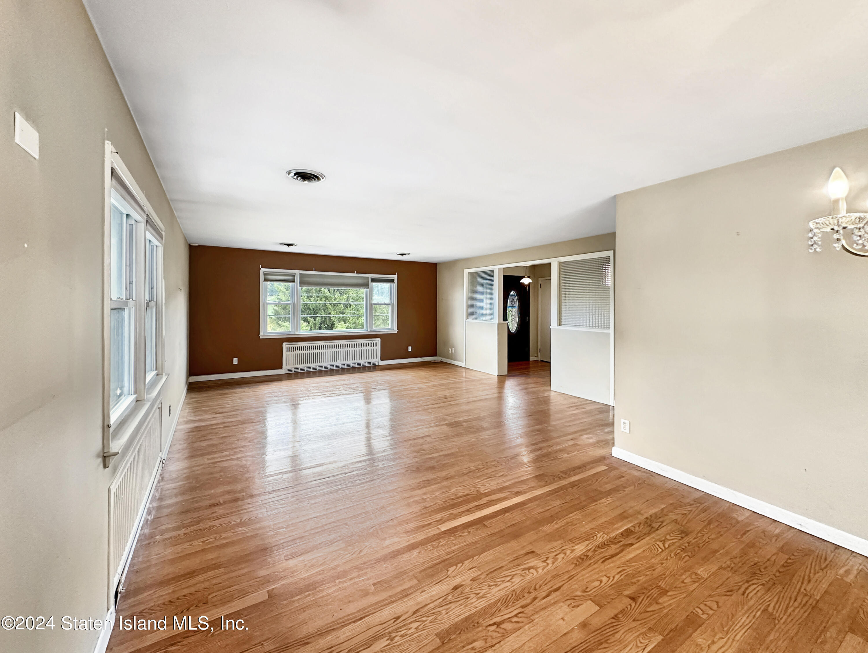 1085 Todt Hill Road Staten Island, NY 10304 - Photo 8 of 14 a view of an empty room with window and wooden floor