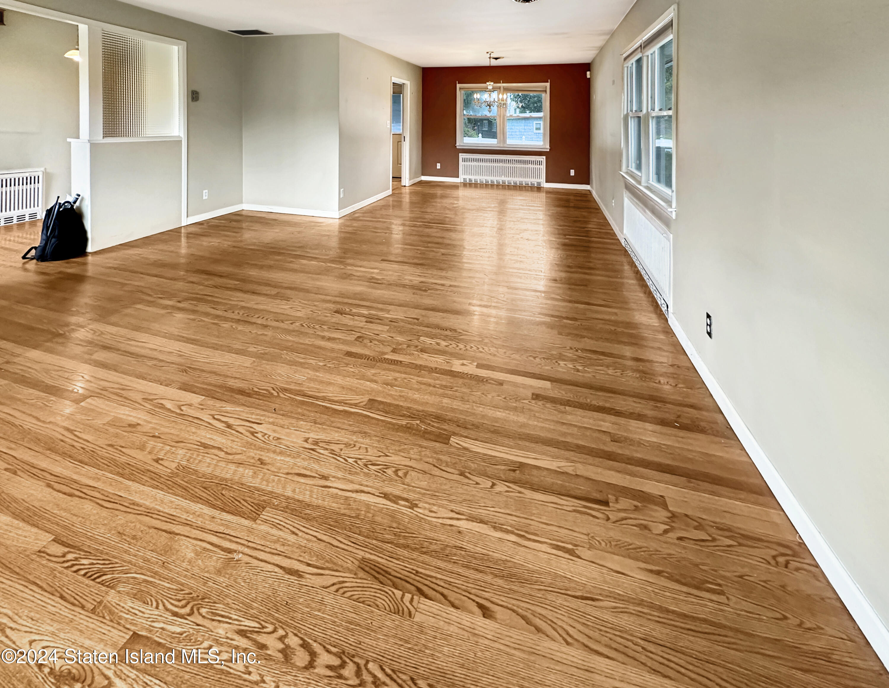 1085 Todt Hill Road Staten Island, NY 10304 - Photo 9 of 14 a view of an empty room with window and wooden floor