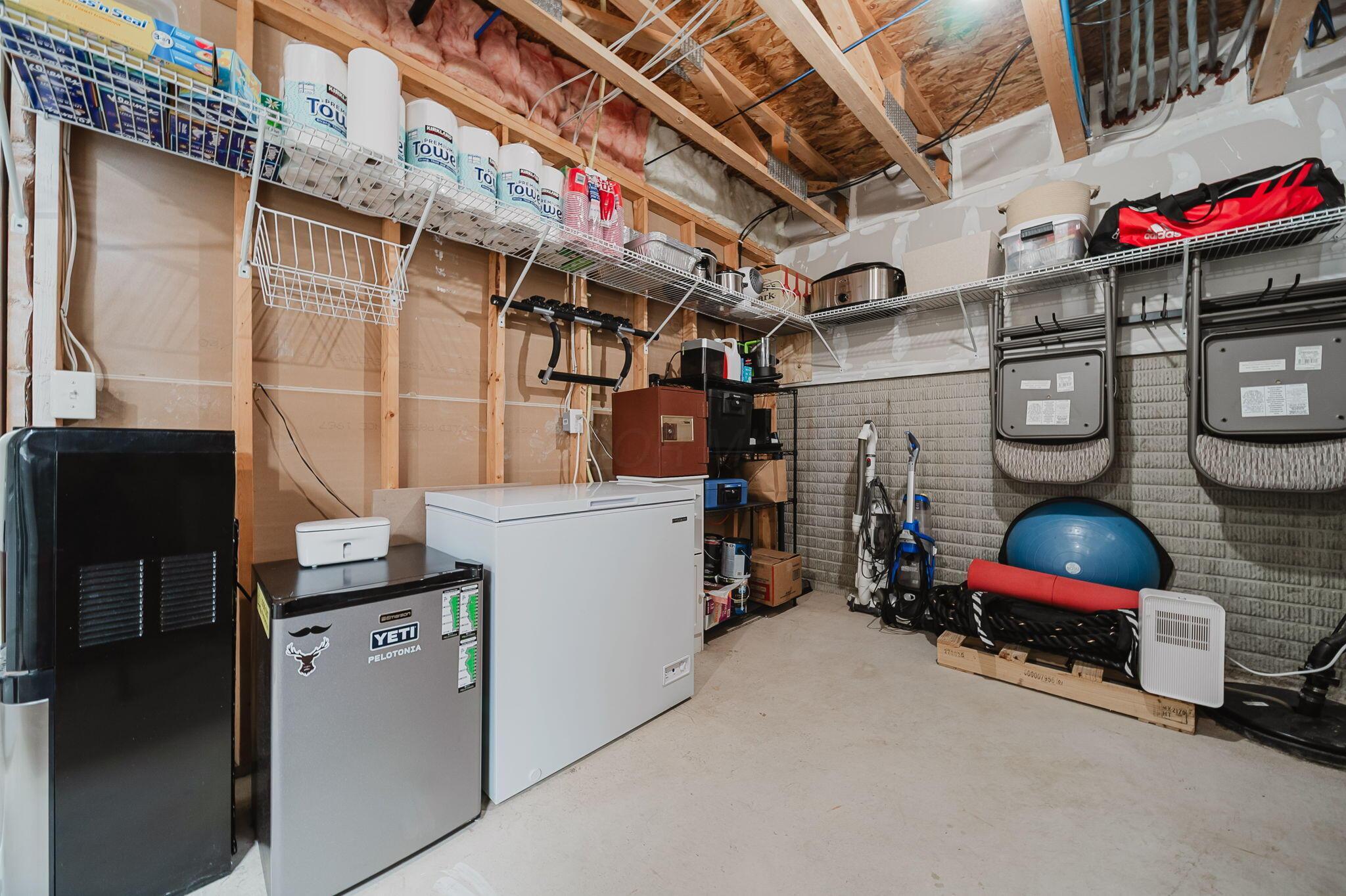 6186 Needletail Road, Unit 66 Columbus, OH 43230 - Photo 30 of 48 Unfinished section of lower level showcases ample storage, access to mechanicals, and washer dryer space!