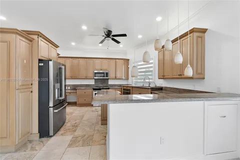 a kitchen with a sink stove and microwave